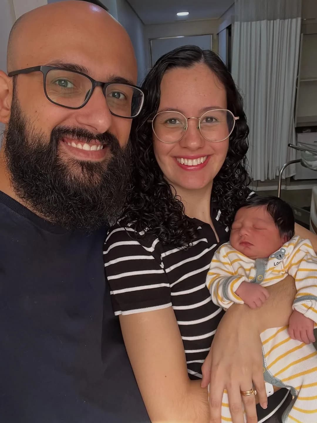 Família com o recém-nascido no quarto da maternidade